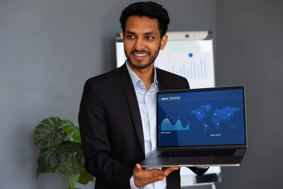 Business professional presenting CRM analytics on a laptop screen, representing top Salesforce consulting companies in India